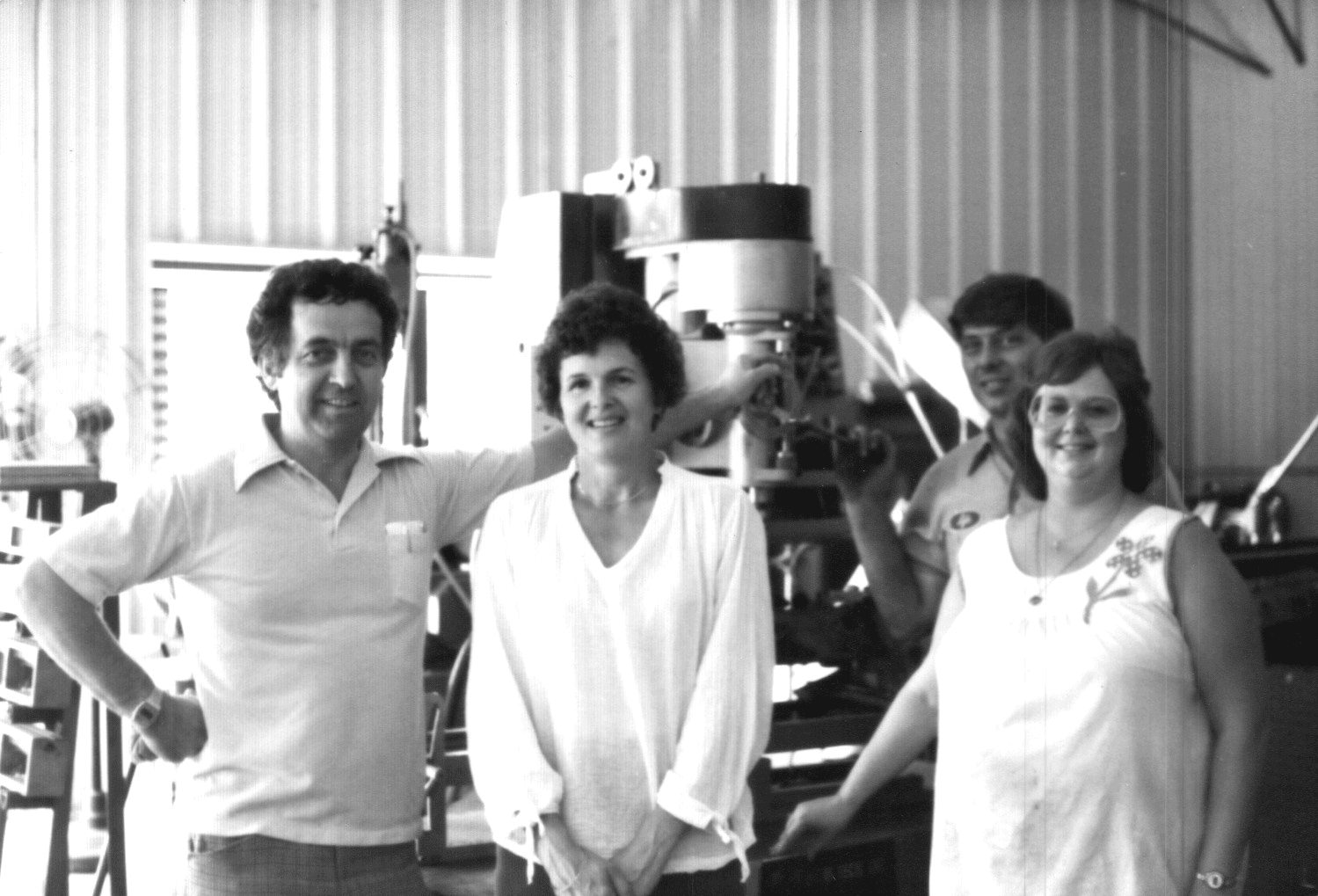 Dave and Muriel Arnold (left) stand in front of a flywheel grinder in the 1980s (Courtesy DCM Tech, Inc.)