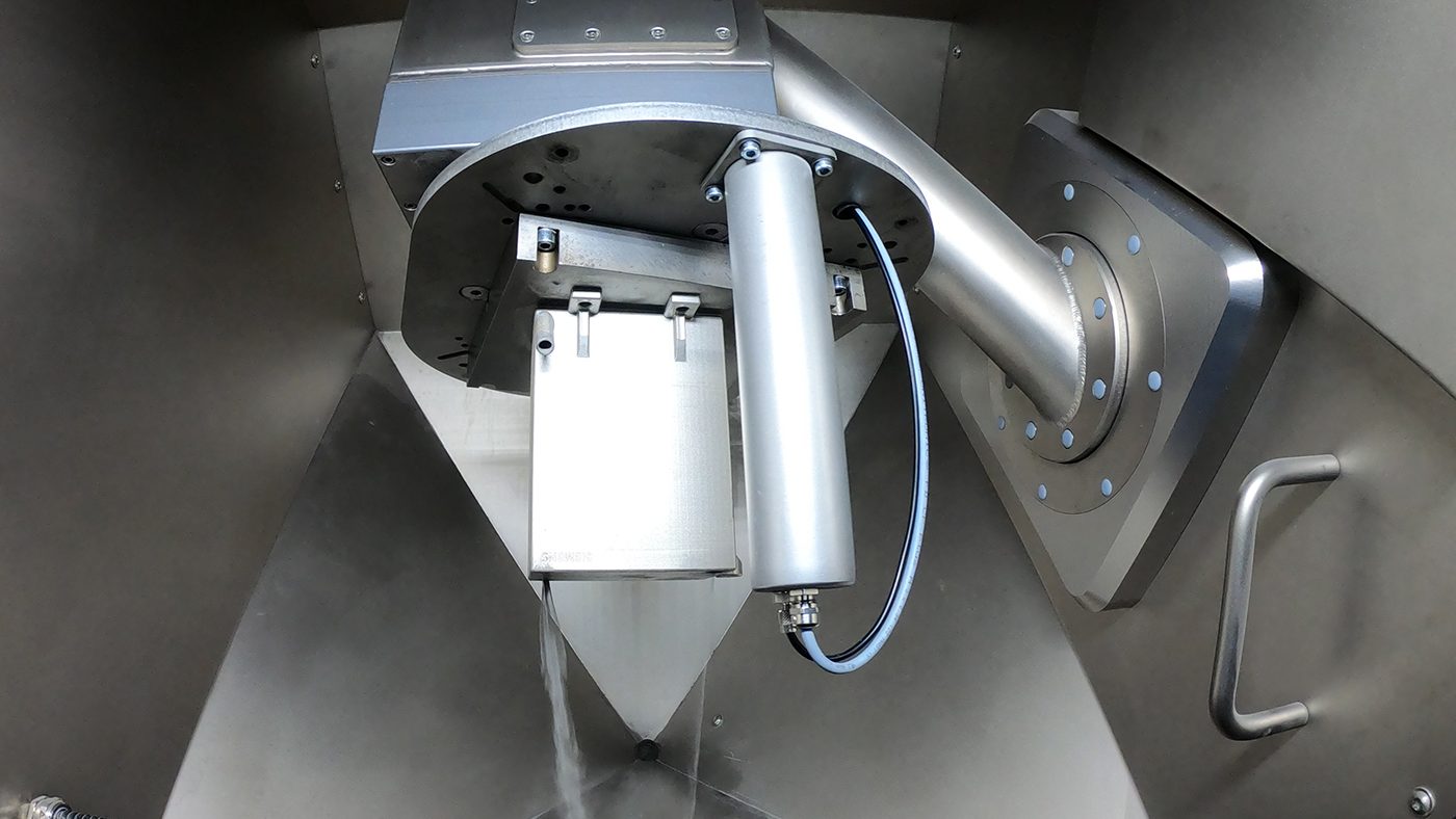 Fig. 10 The chemical reactor being depowdered inside a Solukon machine after simulation and planning using Pathfinder software (Courtesy Solukon)