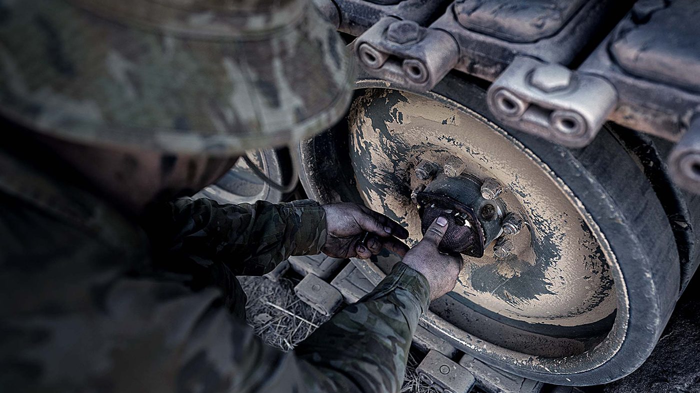Fig. 9 A wheel bearing cover produced in the field using SPEE3D’s Cold Spray Additive Manufacturing technology being fitted to an M113 fully tracked armoured personnel carrier (APC) (Courtesy SPEE3D)