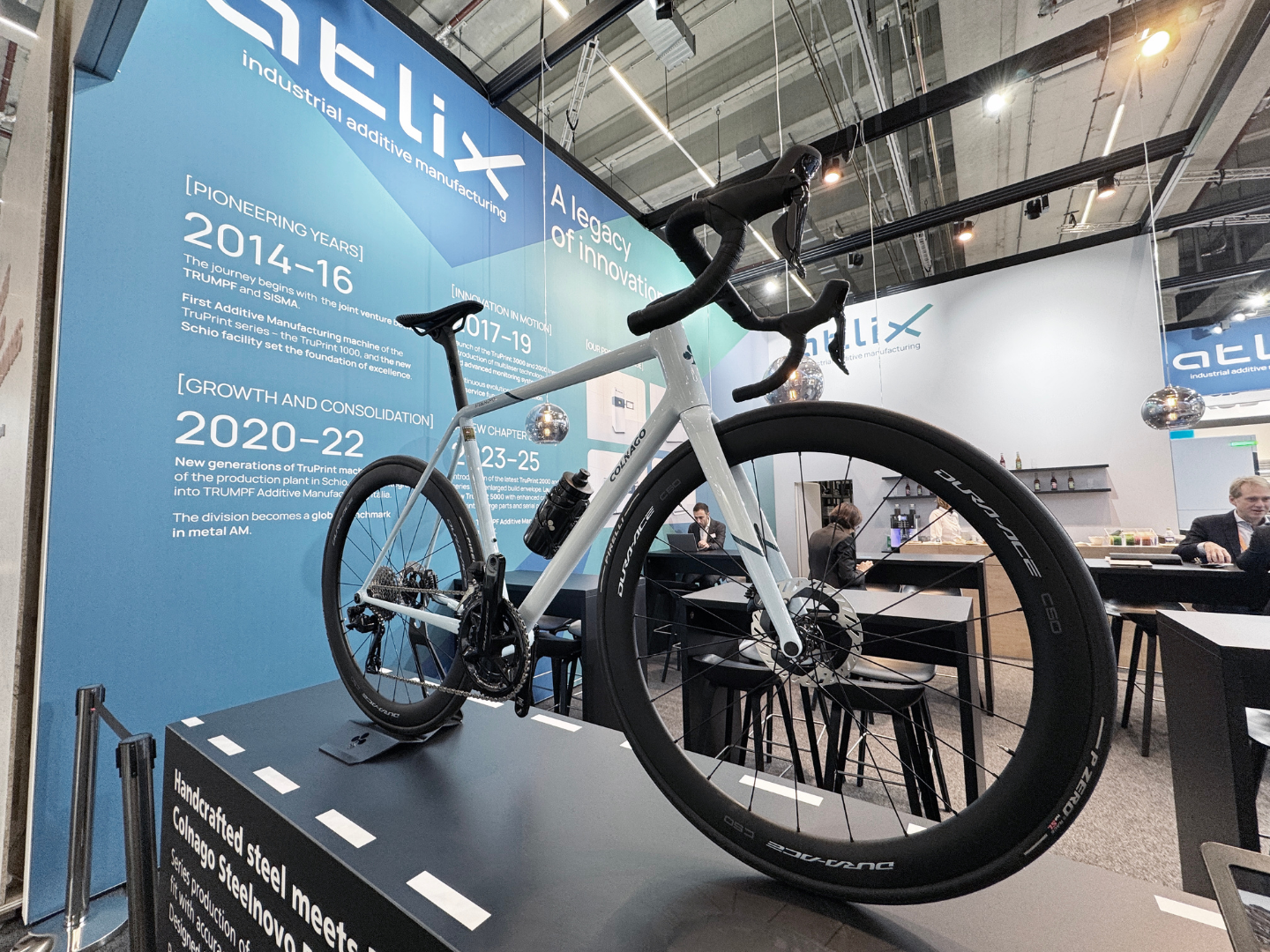 Fig. 2 Colnago’s Steelnovo displayed on the ATLIX stand at Formnext 2025, where the bike drew attention as an example of steel frame design enabled by metal Additive Manufacturing (Courtesy Nick Williams)