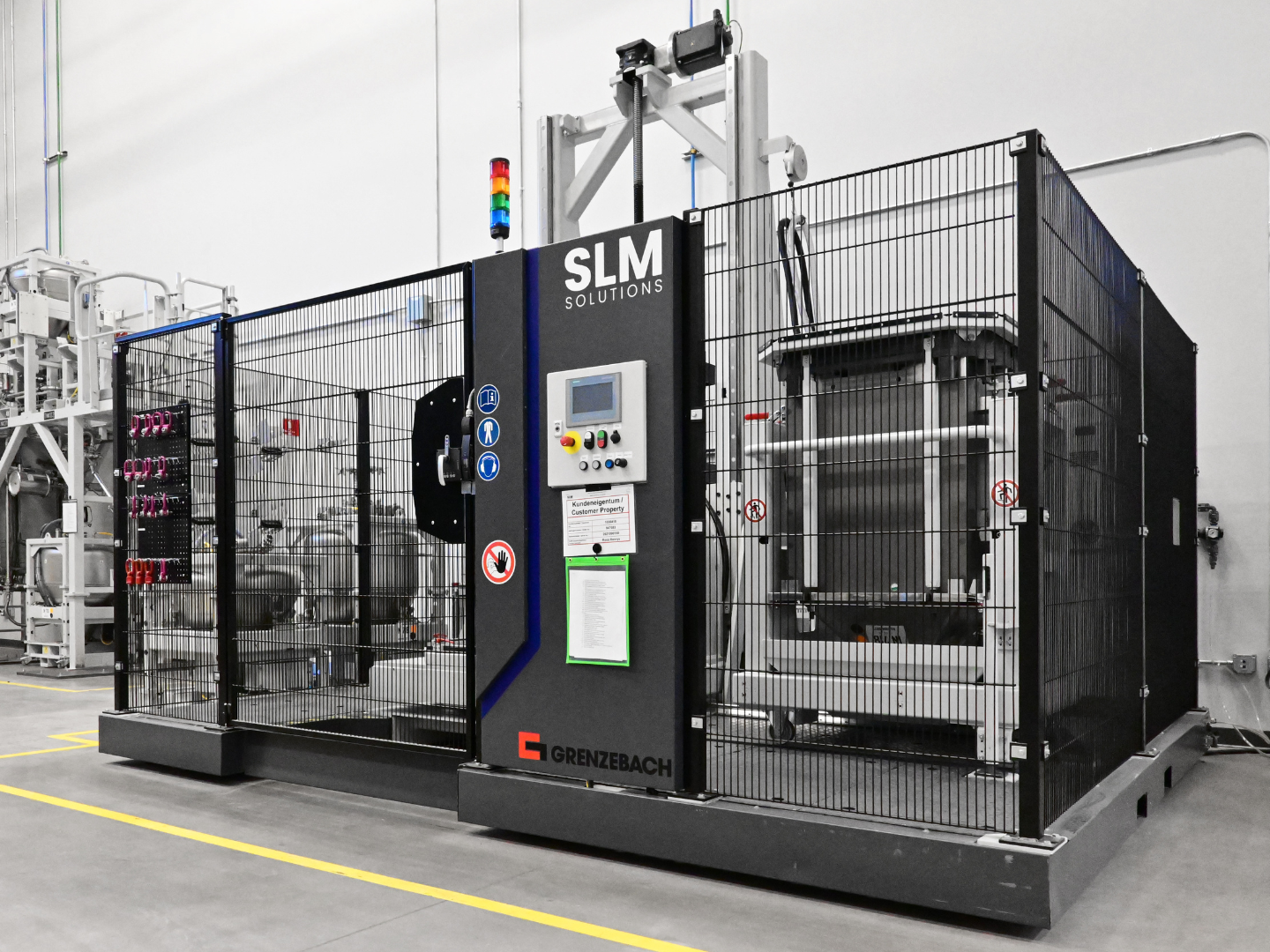 Fig. 6 Grenzebach automated exchange cell for Nikon’s NXG workflow: a completed build cylinder is swapped for a prepared chamber to restart production quickly, leaving around 80-90% of the powder in place (Courtesy Nikon)