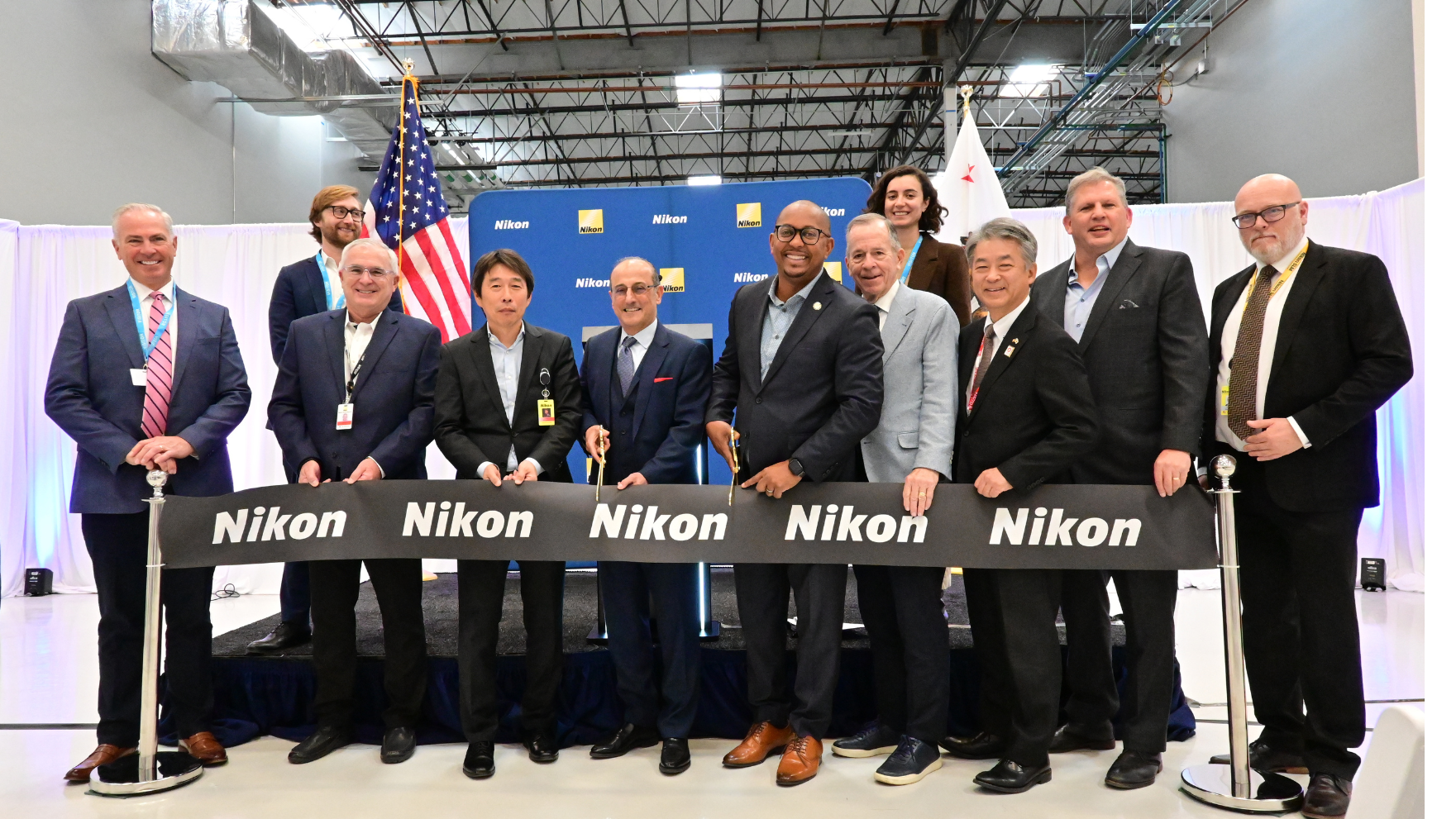 Fig. 12 At the opening of Nikon Advanced Manufacturing’s AM Technology Center in Long Beach, January 2025. Left to right: Charlie Grace; David McKee; Yuichi Shibazaki; Hamid Zarringhalam; Long Beach Mayor Rex Richardson; Adm. Mike Mullen (Ret., USN); Kenko Sone, then Consul-General of Japan; Hon. James Geurts; Gerhard Bierleutgeb. Back row: Jack Cunningham (left); Maria Onorato (right) (Courtesy Nikon)
